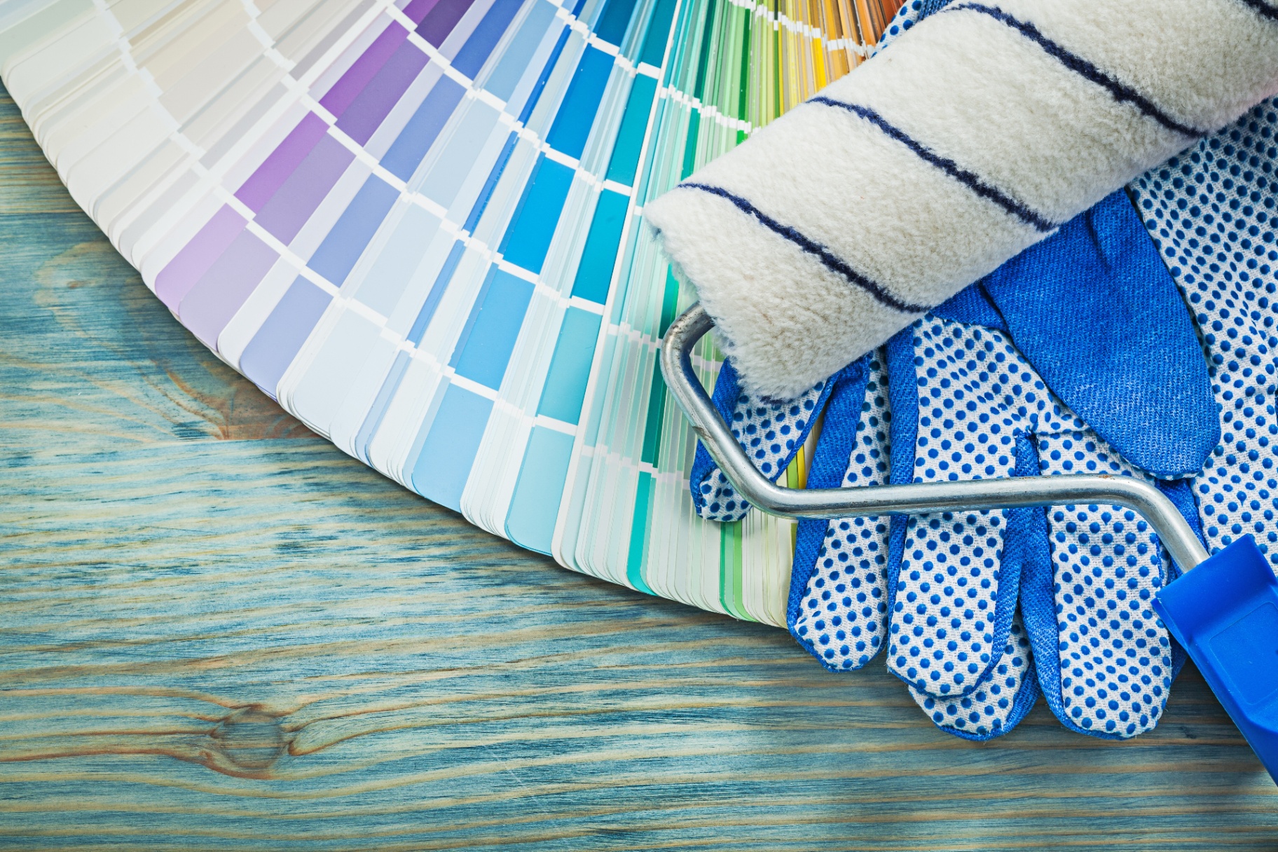 Experienced painter carefully painting exterior trim at golden hour